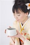 Japanese Woman Holding Bowl of Herbal Tea