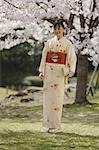 Woman in Kimono Standing Holding Clutch Purse