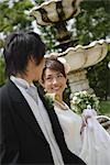 Bride and Groom Walking in Garden