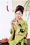 Young Woman in Kimono Eating Watermelon