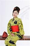 Woman in Kimono Sitting on Bench
