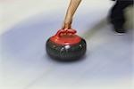 Curler Throwing a Curling Stone