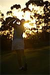 Woman Playing Golf In the Evening