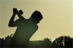 Man Playing Golf in the Evening