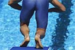 Swimmer on diveboard preparing