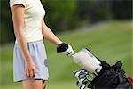 Female golfer with golf bag