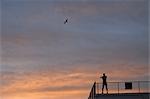 Athlete Stretching Against a Sunrise