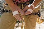 Rock Climber Tying Into His Harness