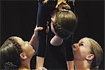 Gymnasts holding girl