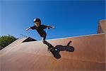 Boy skateboarding in skate park