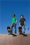 Skateboarders standing on top of skate park