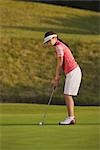 Female golfer hitting ball