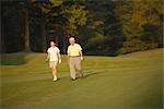 Front view of golfers walking on golf course