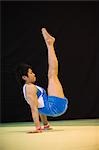 A young man performing gymnastics