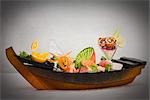 Sashimi and Sushi Rolls decorated in Serving Boat
