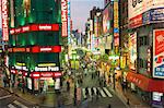 Busy streets and neon signs in the evening at Shinjuku station, Shinjuku, Tokyo, Japan, Asia