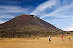 Hikers in front of Mount Ngauruhoe, 2287m, on the Tongariro Crossing, in the oldest national park in New Zealand, Tongariro National Park, UNESCO World Heritage Site, Taupo, North Island, New Zealand, Pacific