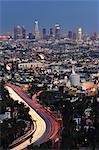 Downtown district skyscrapers and car lights on a city highway, Los Angeles, California, United States of America, North America