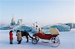 A horse and carriage ride and snow and ice sculptures at the Ice Lantern Festival, Harbin, Heilongjiang Province, Northeast China, China, Asia