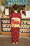 Girl in kimono, yukata buying crepe, Kyoto city, Honshu, Japan, Asia