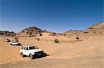 SUV climbing rock, Akakus, Sahara desert, Fezzan, Libya, North Africa, Africa