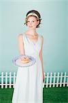 Woman Holding a Doughnut on a Plate