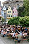 People sitting at outdoor restaurant in the old town, St. Martin church and the Fish Market in the background, Cologne, North Rhine Westphalia, Germany, Europe