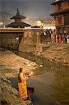 Deux femmes faisant des offrandes (puja) avant l'aube de la rivière Bagmati, à l'extérieur du temple de Shiva pendant le festival hindou de Shivaratri, Pashupatinath, Katmandou, Népal, Asie