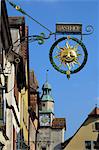 Ornate wrought iron shop sign advertising a gasthof (guesthouse), Rothenburg ob der Tauber, Bavaria (Bayern), Germany, Europe