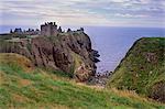 Dunnotar Castle dating from the 14th century, and piper playing, near Stonehaven, Aberdeenshire, Scotland, United Kingdom, Europe