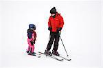 Mother teaching child to ski, Arapahoe Basin Ski Resort, Rocky Mountains, Colorado, United States of America