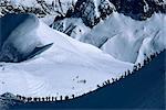 Figures silhouetted walking along the ridge at the top of the Vallee Blanche, Mont Blanc, Chamonix, Rhone Alpes, France, Europe