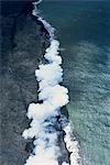 Aerial view of basalt lava field with collapsed roof window into an active flowing lava tube on the south flank of Kilauea volcano in Puna, Big Island, Hawaii, Hawaiian Islands, United States of America, Pacific, North America