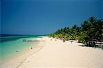 Touristes sur la plage tropicale à West Bay, à l'extrémité ouest de Roatan, la plus grande des îles de la baie en Honduras, Caraïbes, Amérique centrale