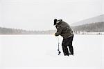 Man Ice Fishing Near Kamloops, British Columbia, Canada