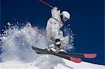 Man in white & grey camo suit off-piste.