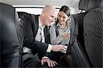 man and woman in car with laptop