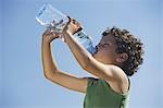 Low angle of young boy drinking water