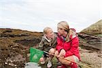 Mother and daughter by rock pools