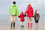 Family holding hands in the sea