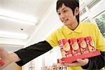 Convenience store clerk displaying