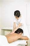 Massage therapist applying body massage