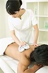 Massage therapist applying body massage