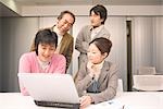 Four people discussing in office