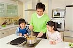 Father and children cooking