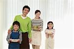 Parents and children holding breakfast dishes