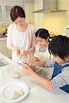 Mother and children cooking rice ball