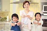 Mother and children holding rice ball