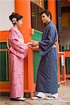 Young couple in kimono visiting Shinto Shrine