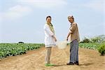 Senior couple standing in field